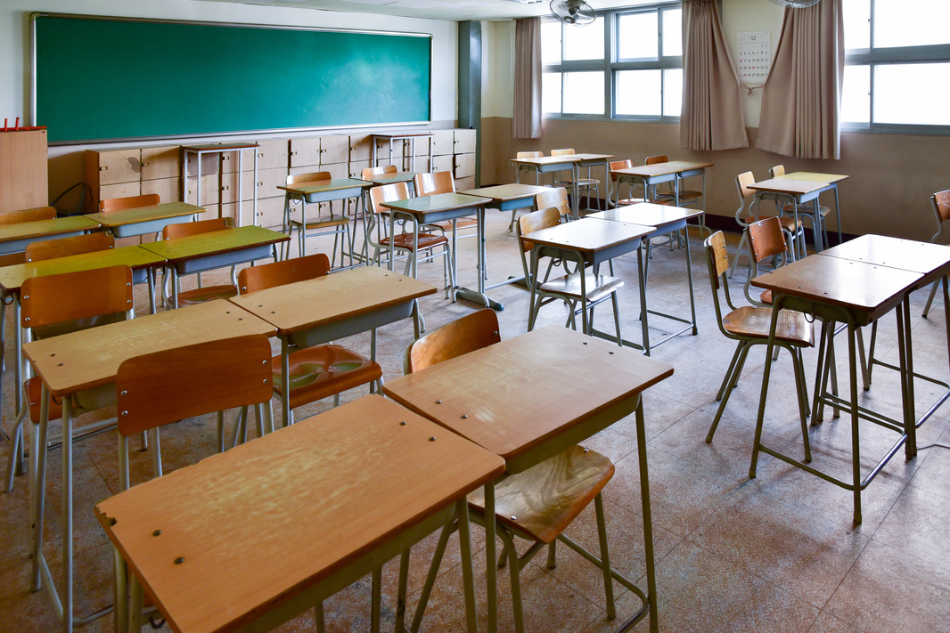 School classroom with school desks and blackboard.